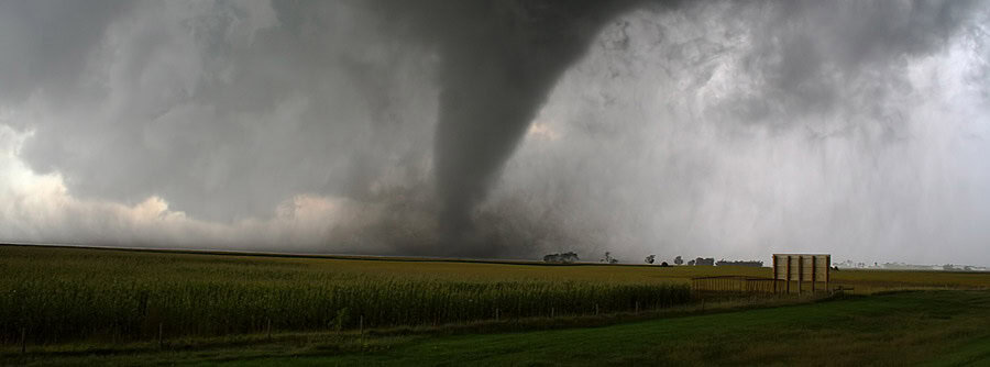 Storm clouds and tornado over a field